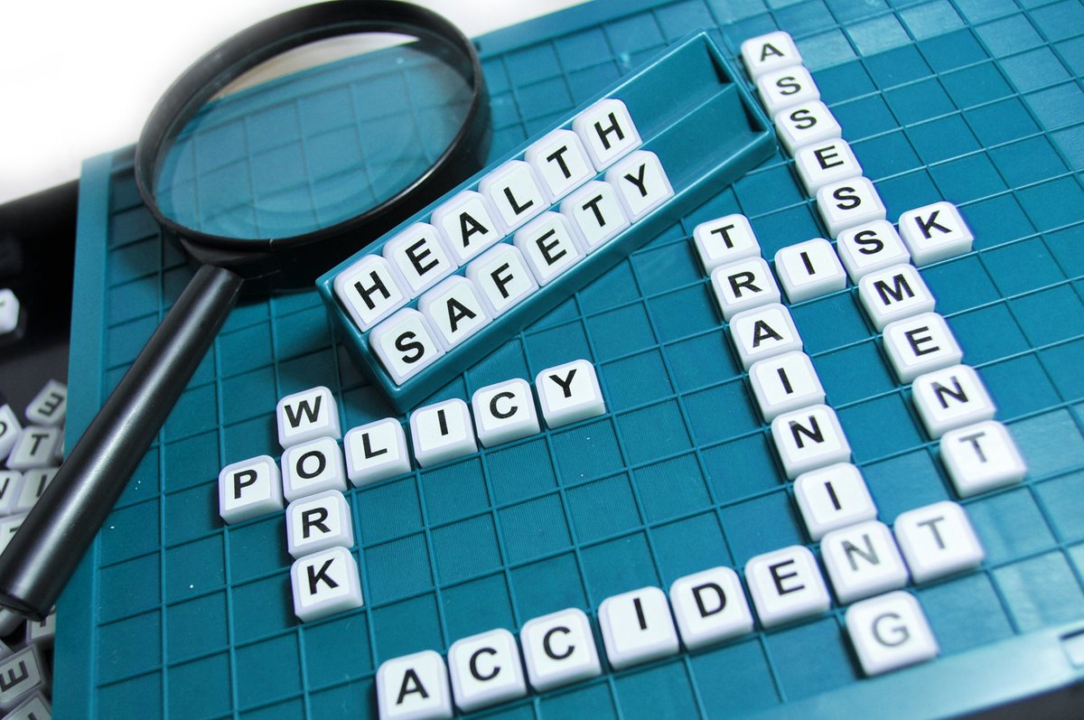 Letter tiles spelling health, safety, policy, training, risk assessment and accident.